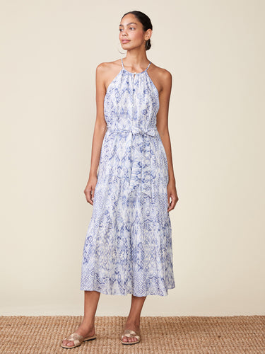 Woman wearing a floral dress on a beige background