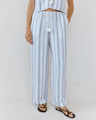 Person wearing a light blue and white striped outfit with a plain background