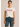 Woman wearing a white t-shirt with red lip prints and text on a beige background