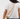 A person wearing a white t-shirt and blue jeans, shown from the back, carrying a light beige leather shoulder bag with a matching strap and silver hardware.