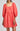 Coral dress with lace details on a plain background