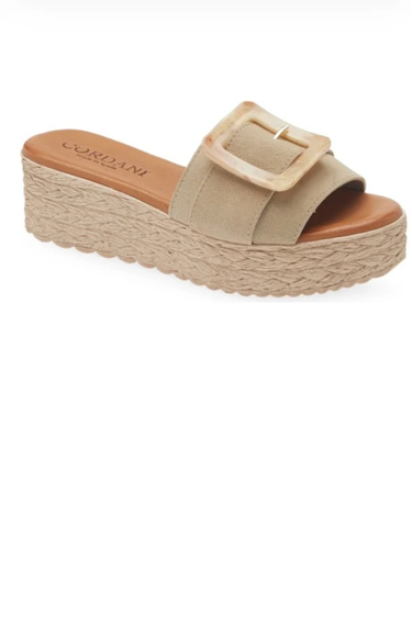 Beige sandal with a buckle on a white background