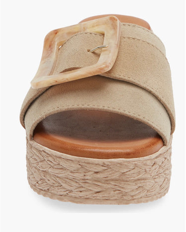 Beige sandal with woven sole on a white background