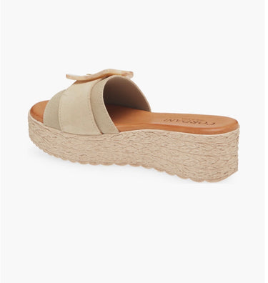 Beige sandal with a bow on a white background