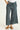 Green wide-leg pants worn by a person on a white background