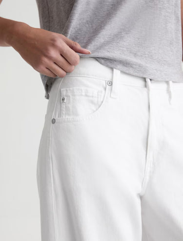 White pants worn by a person on a white background