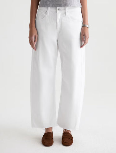 Person wearing white wide-leg jeans on a white background