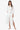 woman wearing the white Eyelet Trim Long White Shirt Dress standing with a white background