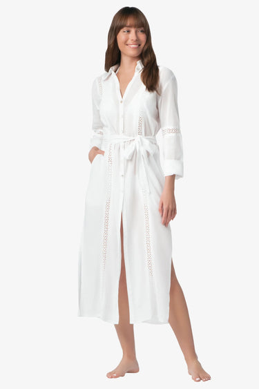 woman wearing the white Eyelet Trim Long White Shirt Dress standing with a white background