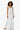 woman wearing scallop crochet tank and skirt with a white background