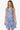 Woman wearing a blue floral dress on a white background