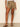 a woman wearing brown semi high rise shorts on a neutral background