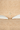 A close up natural straw hat with a tie on a neutral background