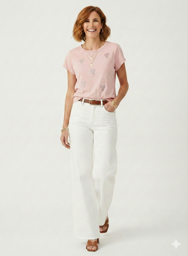 Woman wearing a pink top and white pants on a white background