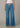 Blue jeans worn by a person on a neutral background