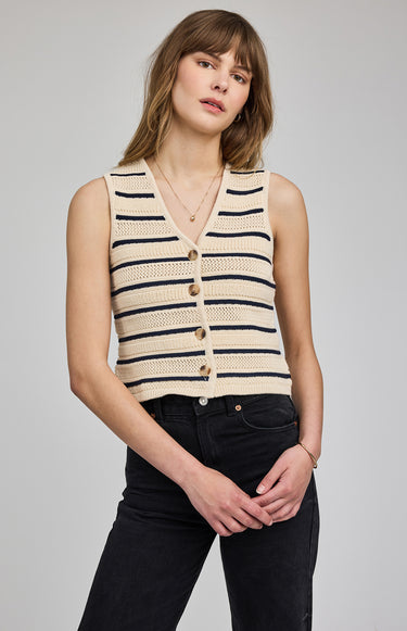 Woman wearing a striped sleeveless cardigan on a gray background