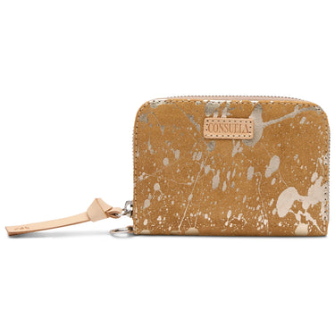 A zip-around wallet in a distressed tan leather finish with a paint-splatter pattern, featuring a light tan leather brand tab on the front and a matching wristlet strap.