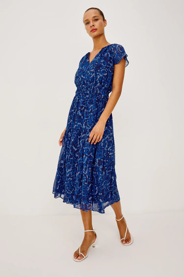 Woman wearing a blue floral dress on a white background