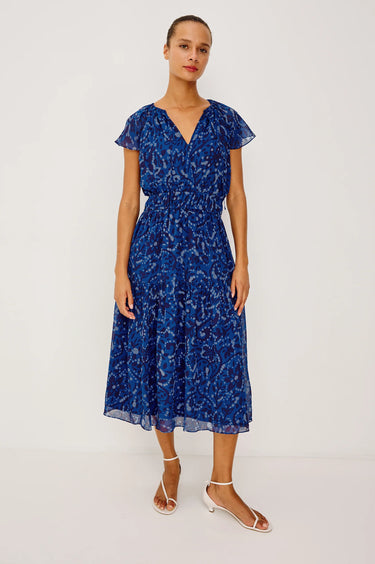 Woman wearing a blue floral dress on a white background