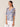 Woman wearing a colorful blouse with a plain background