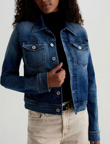Cropped medium-blue denim workwear jacket with adjustable waist tabs, chest flap pockets, and welt pockets.