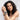 Woman with curly hair wearing multiple bracelets on a light background