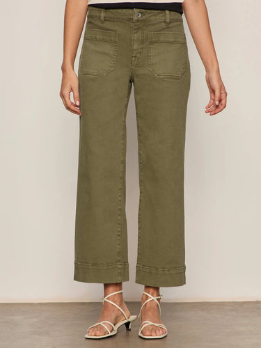 Person wearing olive green pants on a plain background