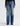 A person wearing a pair of medium-wash blue denim jeans with a straight-leg fit, paired with a black long-sleeve top and dark brown shoes, shown against a plain light gray studio background.