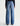 Blue jeans worn by a person on a white background