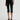 Person wearing black capri pants on a white background