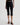 Person wearing black capri pants on a white background