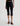 Person wearing black capri pants on a white background