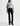 Person wearing a gray sweatshirt with 'Jazz Club' text and dark blue jeans on a white background