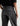 A close up detailed image of a woman wearing  dimensional ashy black wash jeans, with contrasting paneled detailing and a black top on a white background.