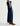 Person wearing blue jeans and brown boots on a white background