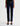 A woman wearing low rise straight dark blue jeans and black heels on a white background.