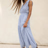 Woman wearing a barletta striped dress against a neutral background