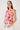 Woman wearing a red floral sleeveless top against a white background