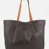 A large dark gray leather tote bag with contrasting brown shoulder straps, shown against a plain light gray background.