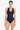 Woman wearing a navy blue swimsuit with buttons on a white background