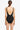 Black swimsuit with open back on a white background