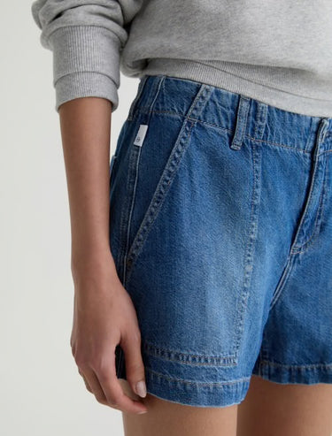 A side pocket view of the medium wash denim jeans.