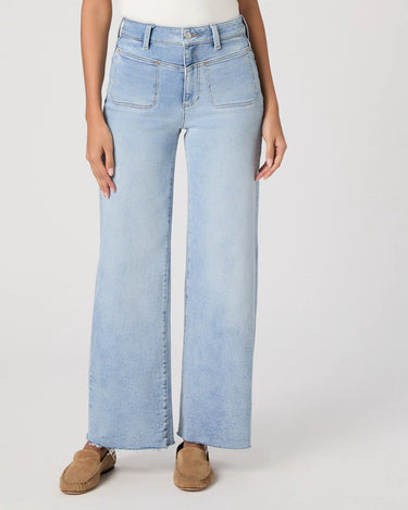High Rise Vintage-inspired light blue jeans worn by a person on a white background