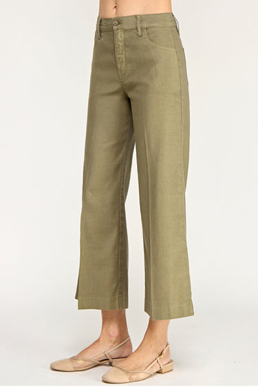 Green pants worn by a person on a white background