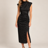 a woman wearing a black lace mock neck  sleeveless dress with a front slit on a white background