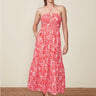 A woman wearing a red and white floral halter midi dress