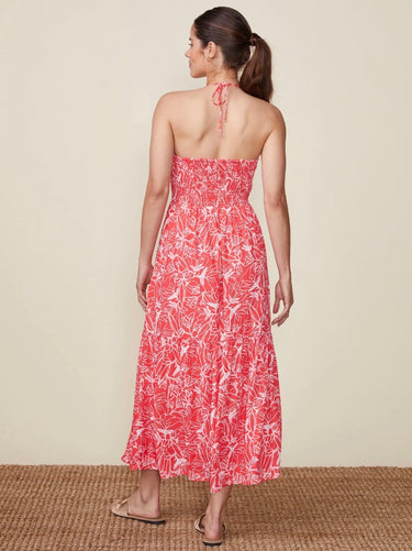 A woman wearing a red and white floral halter midi dress