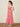 a woman wearing red and white floral halter midi dress.
