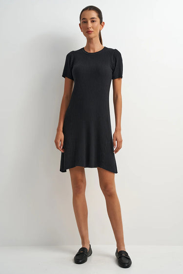 Woman wearing a black dress against a white background