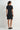 Woman wearing a black dress on a white background